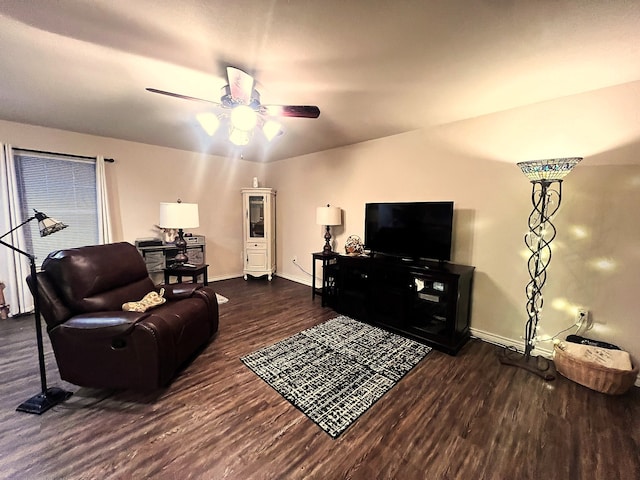 living room with ceiling fan and dark hardwood / wood-style flooring