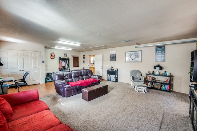 carpeted living room with a textured ceiling