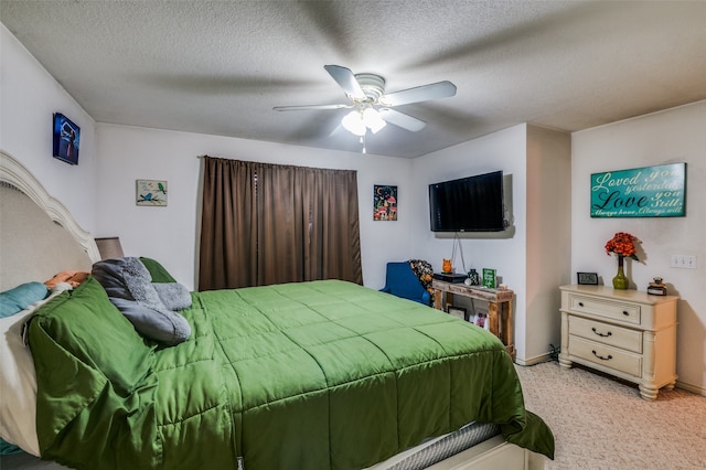 carpeted bedroom featuring a textured ceiling and ceiling fan