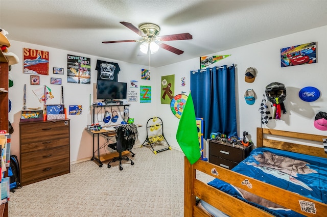 bedroom with a textured ceiling, carpet floors, and ceiling fan