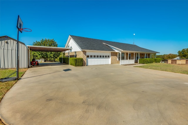 view of front of home with a carport, a front lawn, and a garage