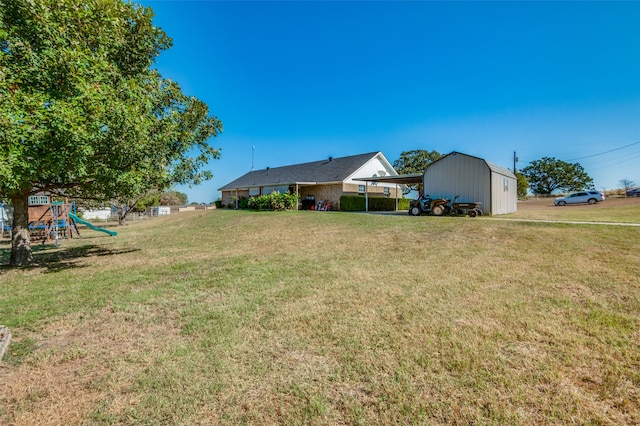 view of yard featuring a carport and a playground