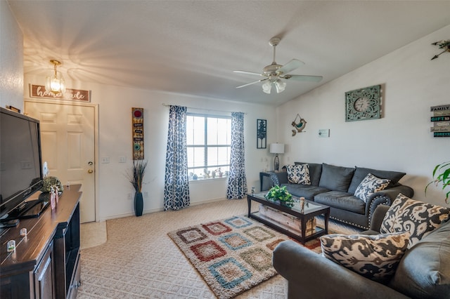 living room with light carpet, lofted ceiling, and ceiling fan with notable chandelier