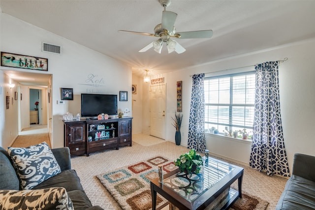 living room featuring light carpet, lofted ceiling, and ceiling fan