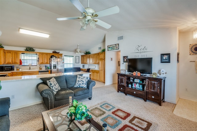 living room featuring light carpet, ceiling fan, sink, and vaulted ceiling