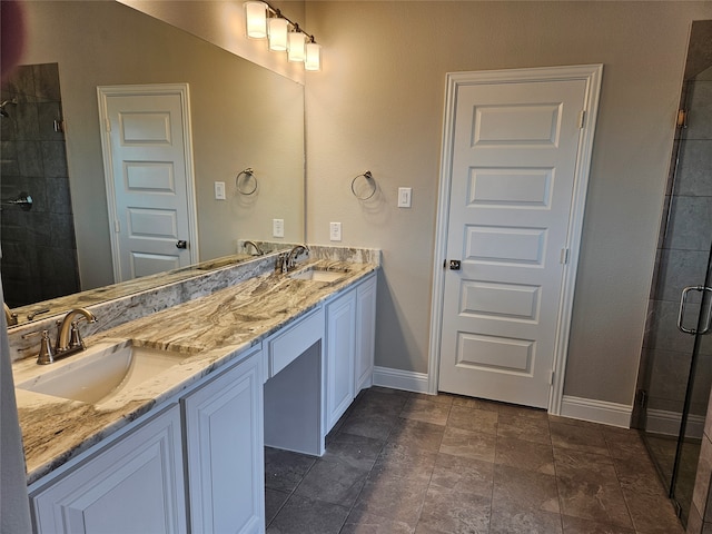 bathroom featuring a shower with door and vanity