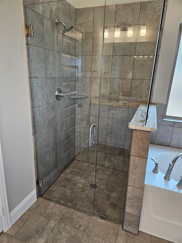 bathroom featuring sink and plus walk in shower