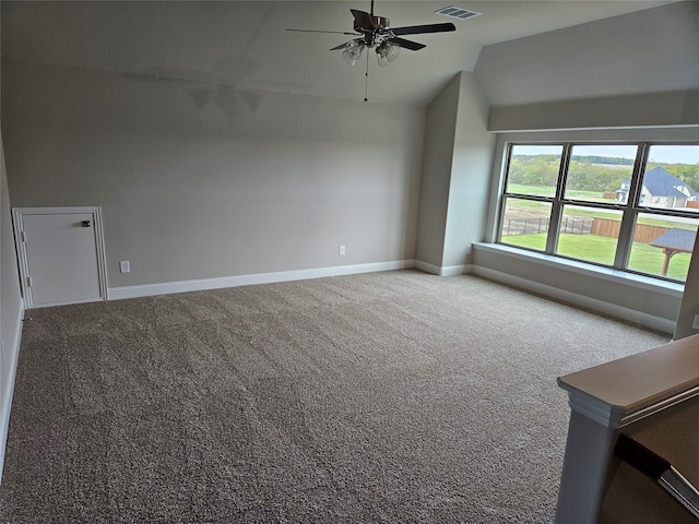 spare room featuring ceiling fan, vaulted ceiling, and carpet