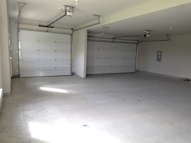 garage with a garage door opener and electric panel