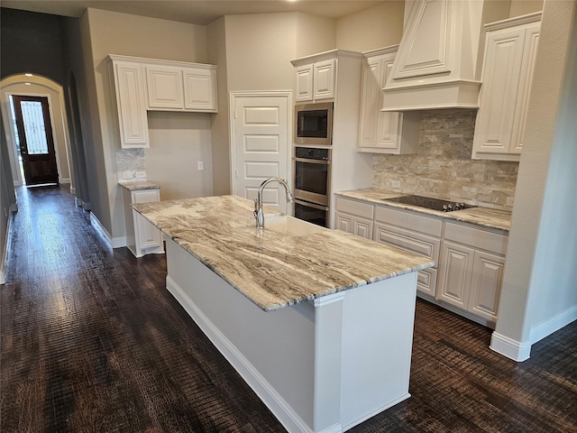 2508 Silo Ln, Van Alstyne, TX 75495 - kitchen featuring black electric cooktop, custom range hood, built in microwave, and white cabinets