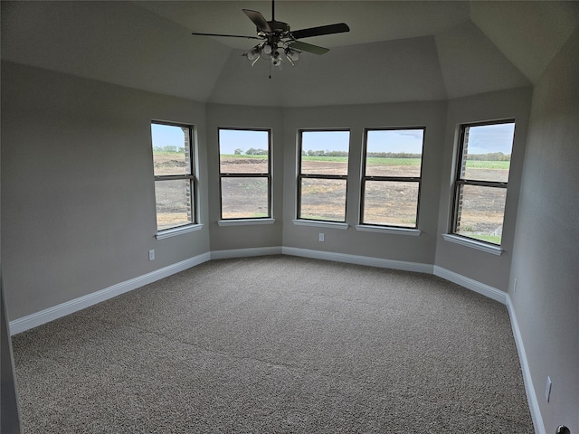 carpeted spare room with lofted ceiling, ceiling fan, and a healthy amount of sunlight