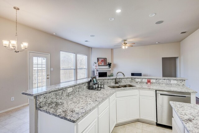 kitchen featuring vaulted ceiling, light tile patterned flooring, white cabinetry, light stone counters, and stainless steel appliances