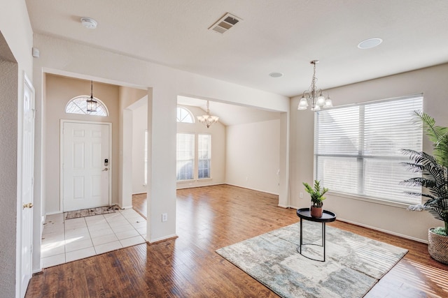 entryway featuring a notable chandelier and light wood-type flooring