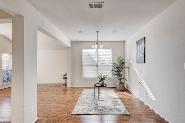 sitting room with a notable chandelier and wood-type flooring