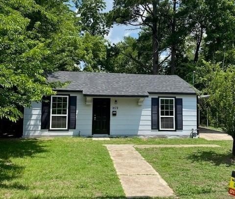 ranch-style home with a front lawn