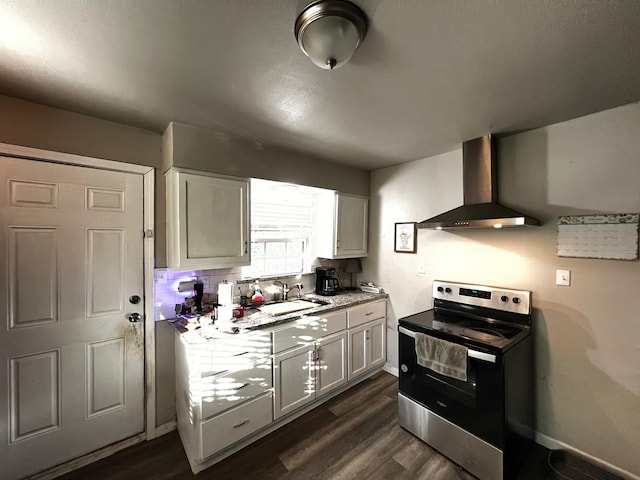 kitchen featuring white cabinets, wall chimney exhaust hood, dark hardwood / wood-style floors, and stainless steel electric stove