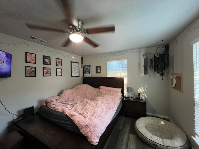 bedroom featuring a textured ceiling, hardwood / wood-style floors, and ceiling fan