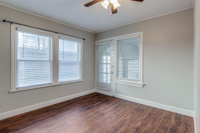 empty room featuring ceiling fan, dark hardwood / wood-style flooring, and ornamental molding