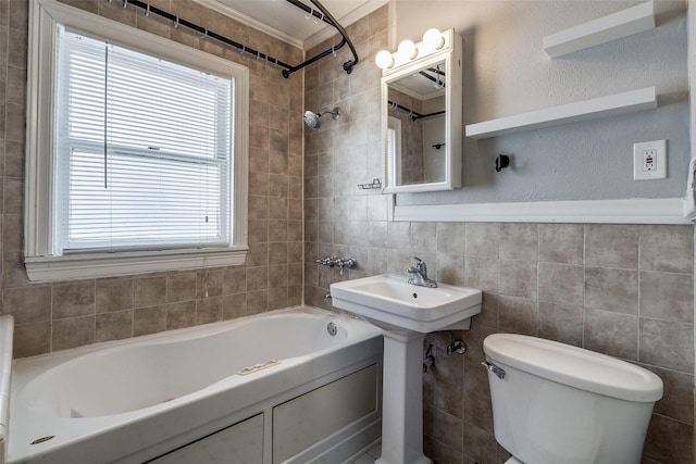 bathroom with plenty of natural light, toilet, ornamental molding, and shower / washtub combination