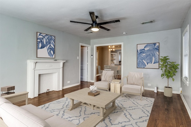 living room with ceiling fan and dark wood-type flooring