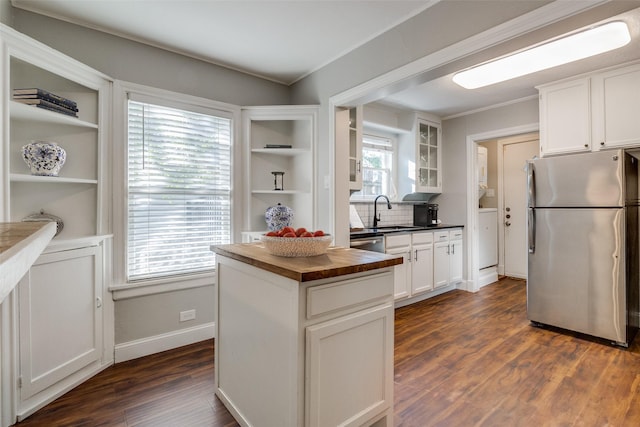 kitchen featuring stainless steel appliances, dark wood-type flooring, sink, white cabinetry, and butcher block counters