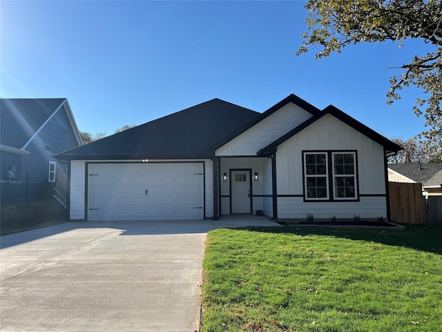 view of front of house with a front yard and a garage