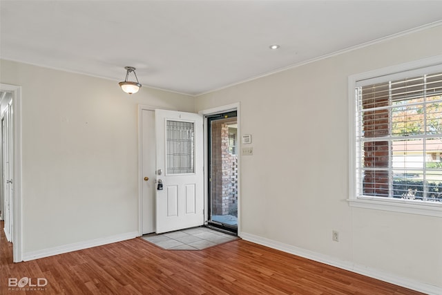 foyer entrance featuring light hardwood / wood-style flooring and ornamental molding