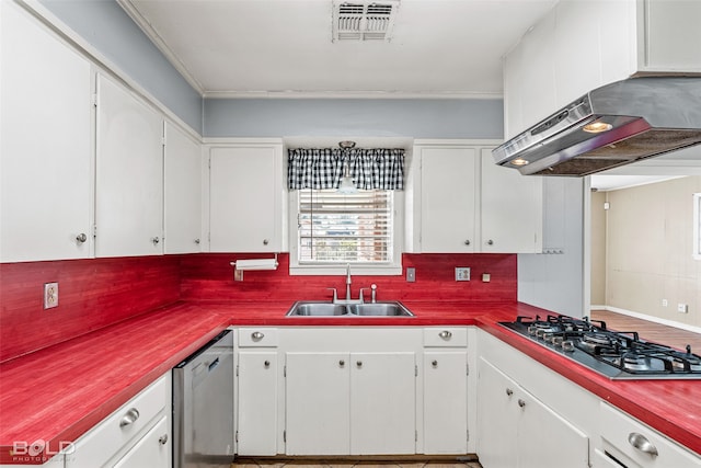 kitchen featuring stainless steel appliances, white cabinetry, sink, and tasteful backsplash