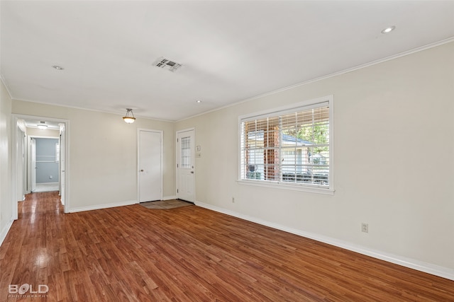 unfurnished room featuring hardwood / wood-style flooring and ornamental molding