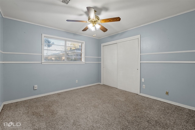 unfurnished bedroom with carpet, a closet, ceiling fan, and crown molding