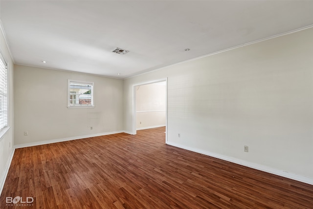 spare room featuring ornamental molding and hardwood / wood-style flooring