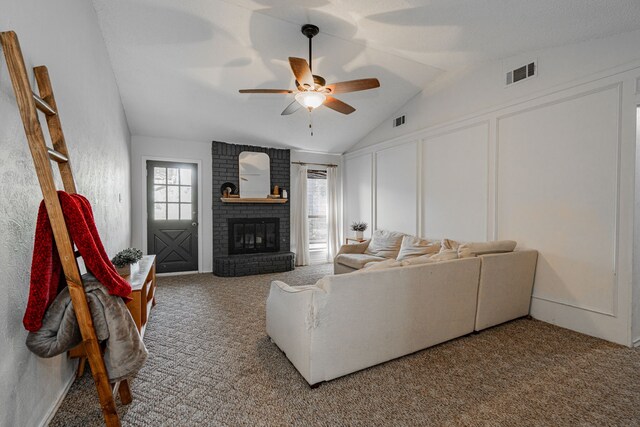 carpeted living room featuring ceiling fan, lofted ceiling, and a fireplace