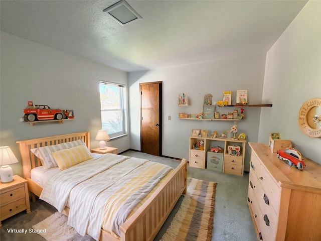 bedroom featuring a textured ceiling and carpet flooring