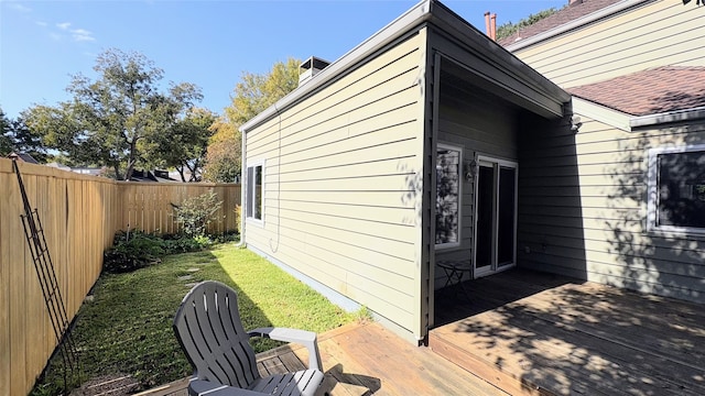 view of side of home with a yard and a wooden deck