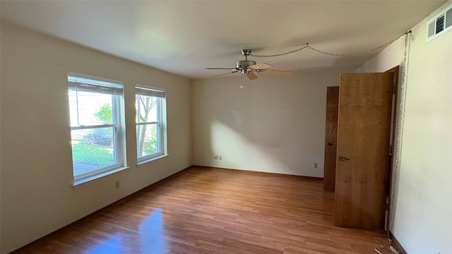 empty room featuring ceiling fan and light wood-type flooring