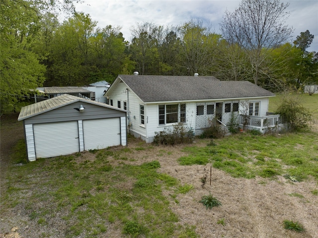 view of front facade with a garage and an outbuilding