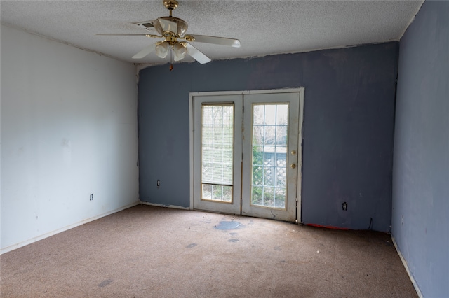 spare room featuring carpet floors, a textured ceiling, and ceiling fan