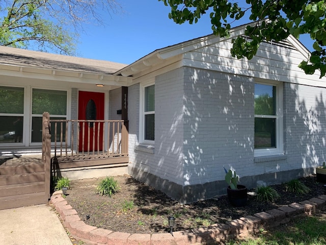 view of side of home with covered porch