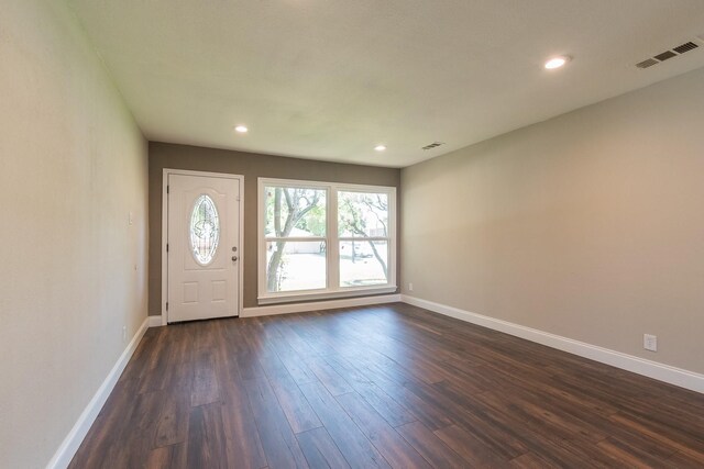 foyer with a healthy amount of sunlight and dark wood-type flooring