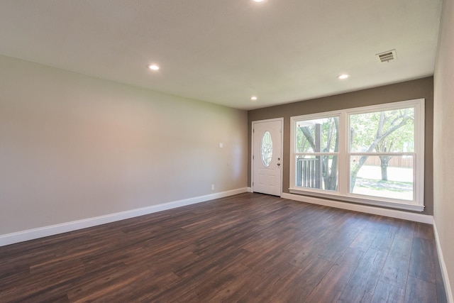 unfurnished room with dark wood-type flooring