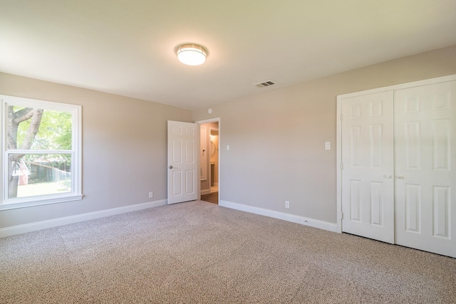 unfurnished bedroom with carpet floors and a closet