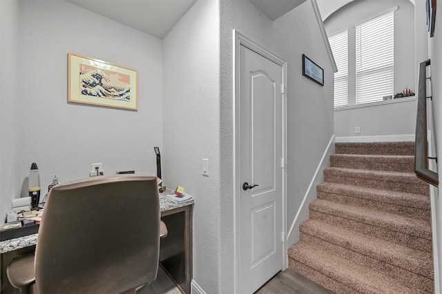 stairs with hardwood / wood-style floors and vaulted ceiling