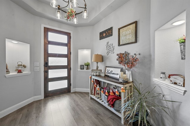 entrance foyer featuring an inviting chandelier and hardwood / wood-style floors