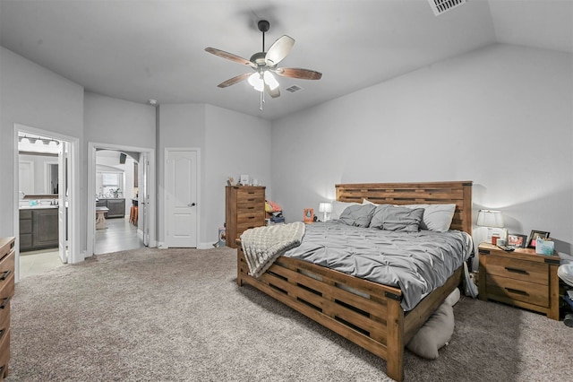 carpeted bedroom with lofted ceiling, connected bathroom, and ceiling fan