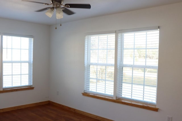 empty room with hardwood / wood-style floors, ceiling fan, and a healthy amount of sunlight