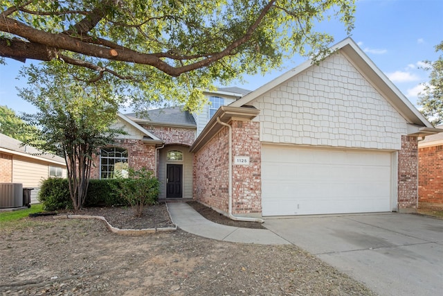 view of front of home featuring cooling unit and a garage