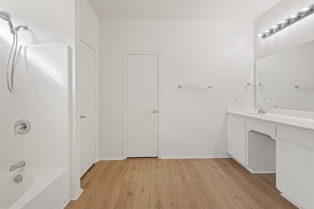 bathroom featuring vanity, wood-type flooring, and shower / tub combination