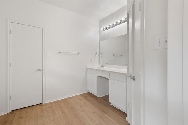 bathroom with hardwood / wood-style floors and vanity