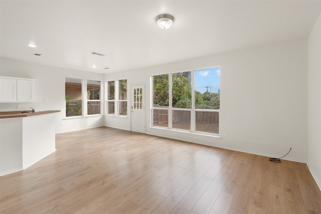 unfurnished living room with light wood-type flooring