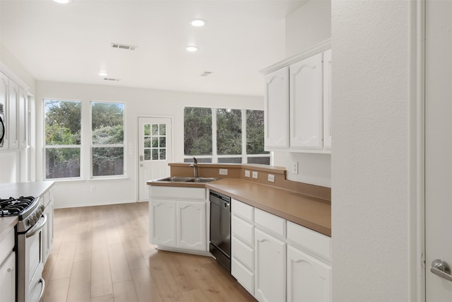 kitchen featuring white cabinets, white range, sink, black dishwasher, and light hardwood / wood-style floors